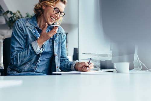 Smiling young businesswoman working at desk