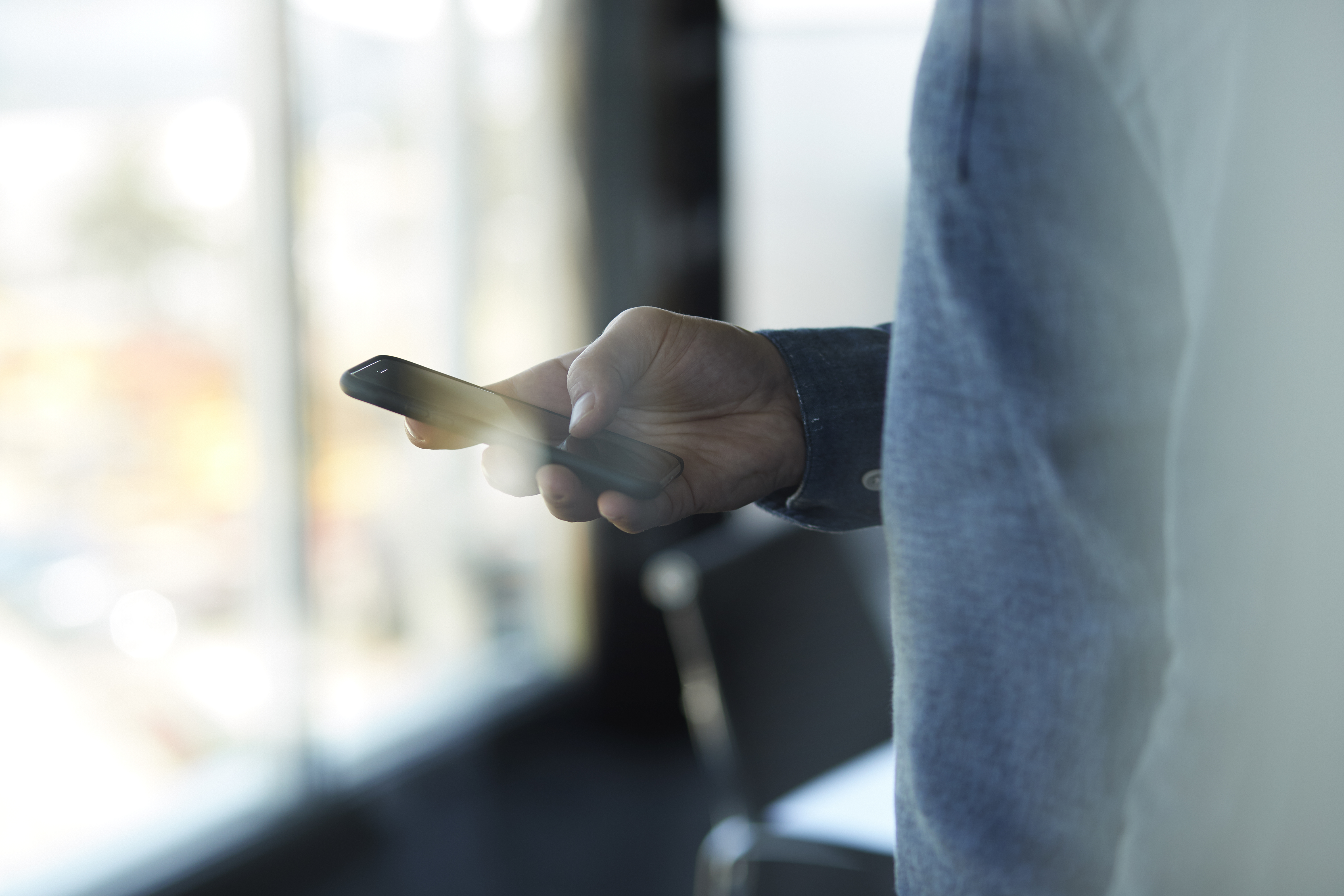 Close-up of businessman using mobile phone
