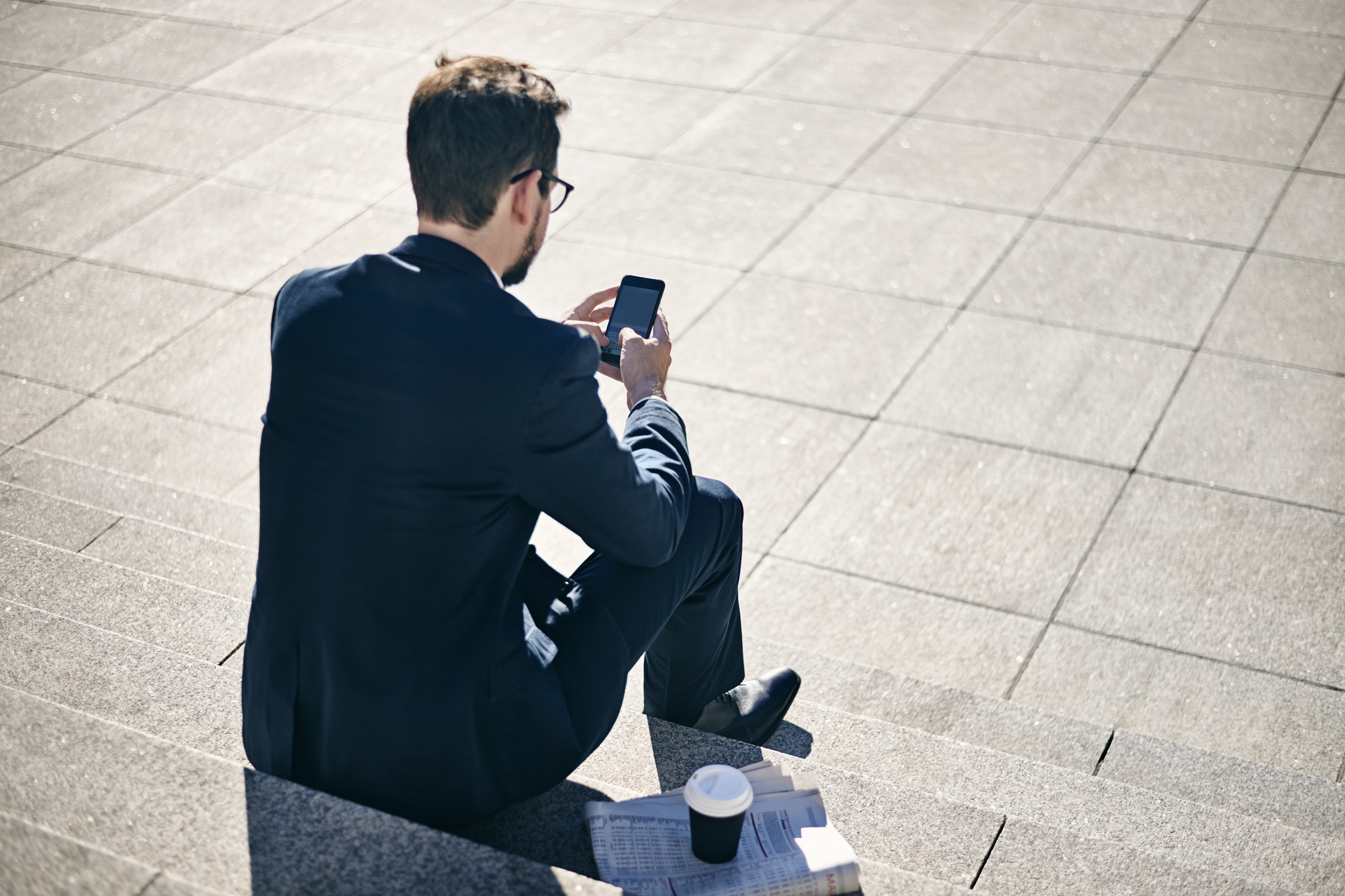 Young businessman texting in Denmark