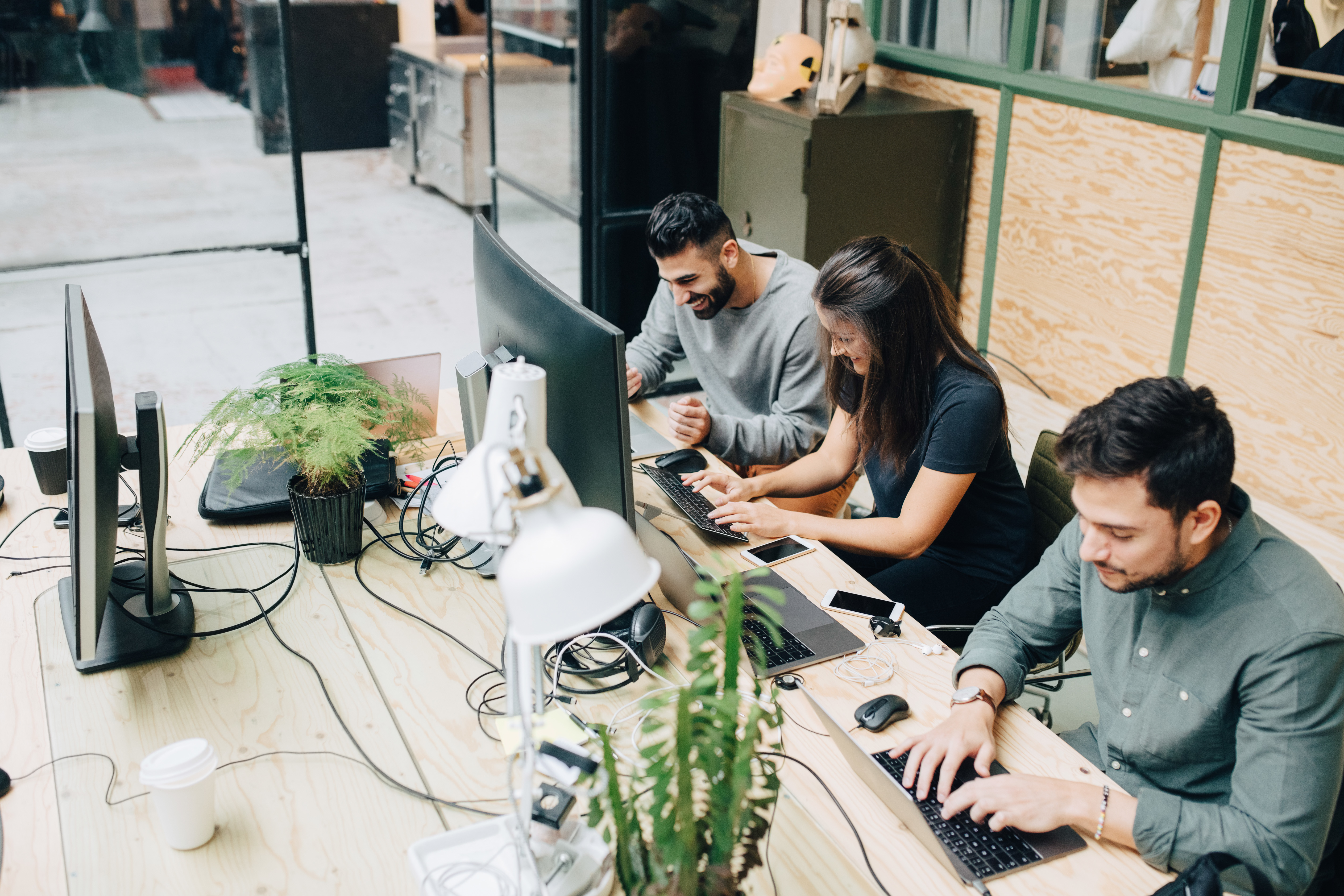 Smiling colleagues with computers in an office