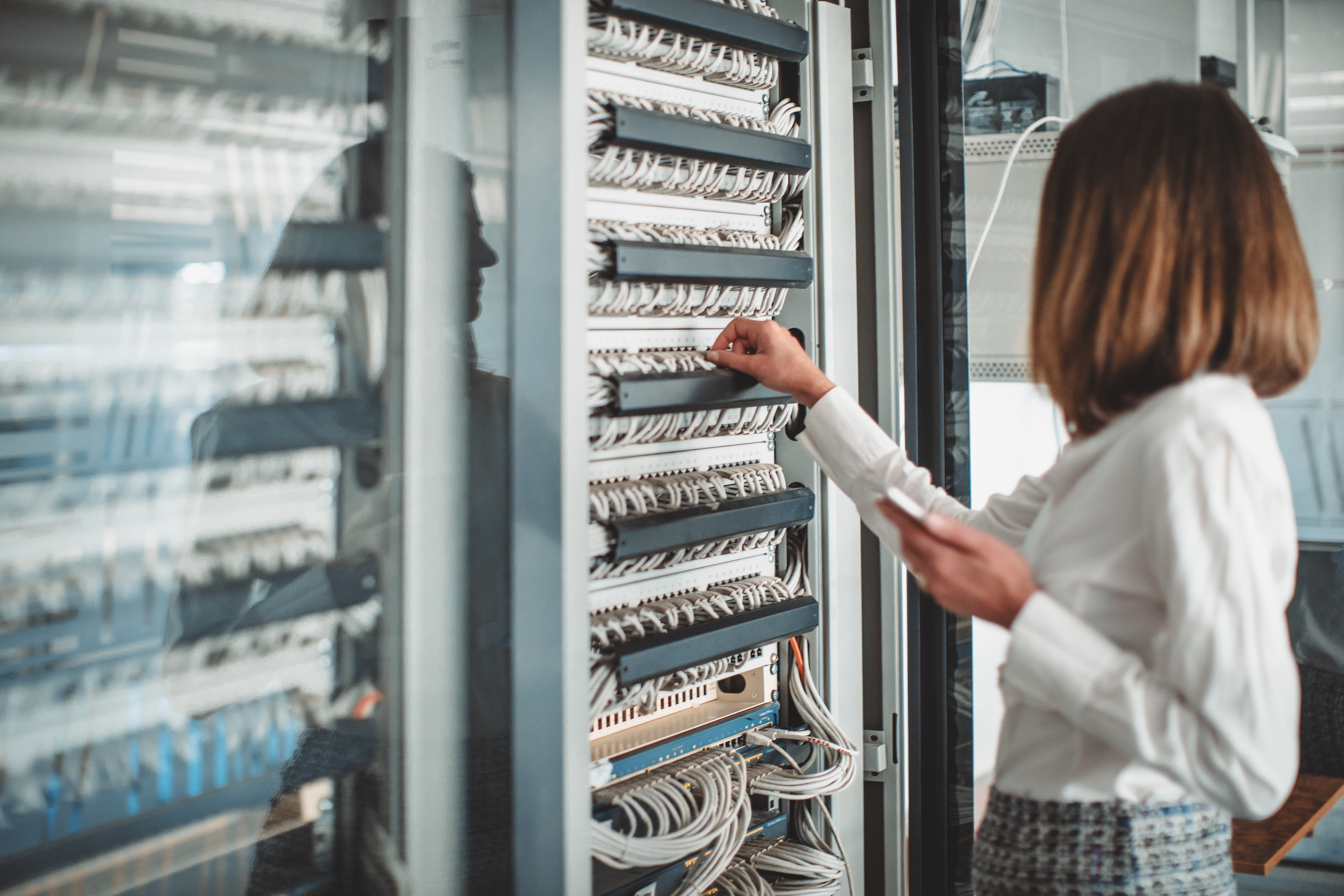 Female computer technician in server room