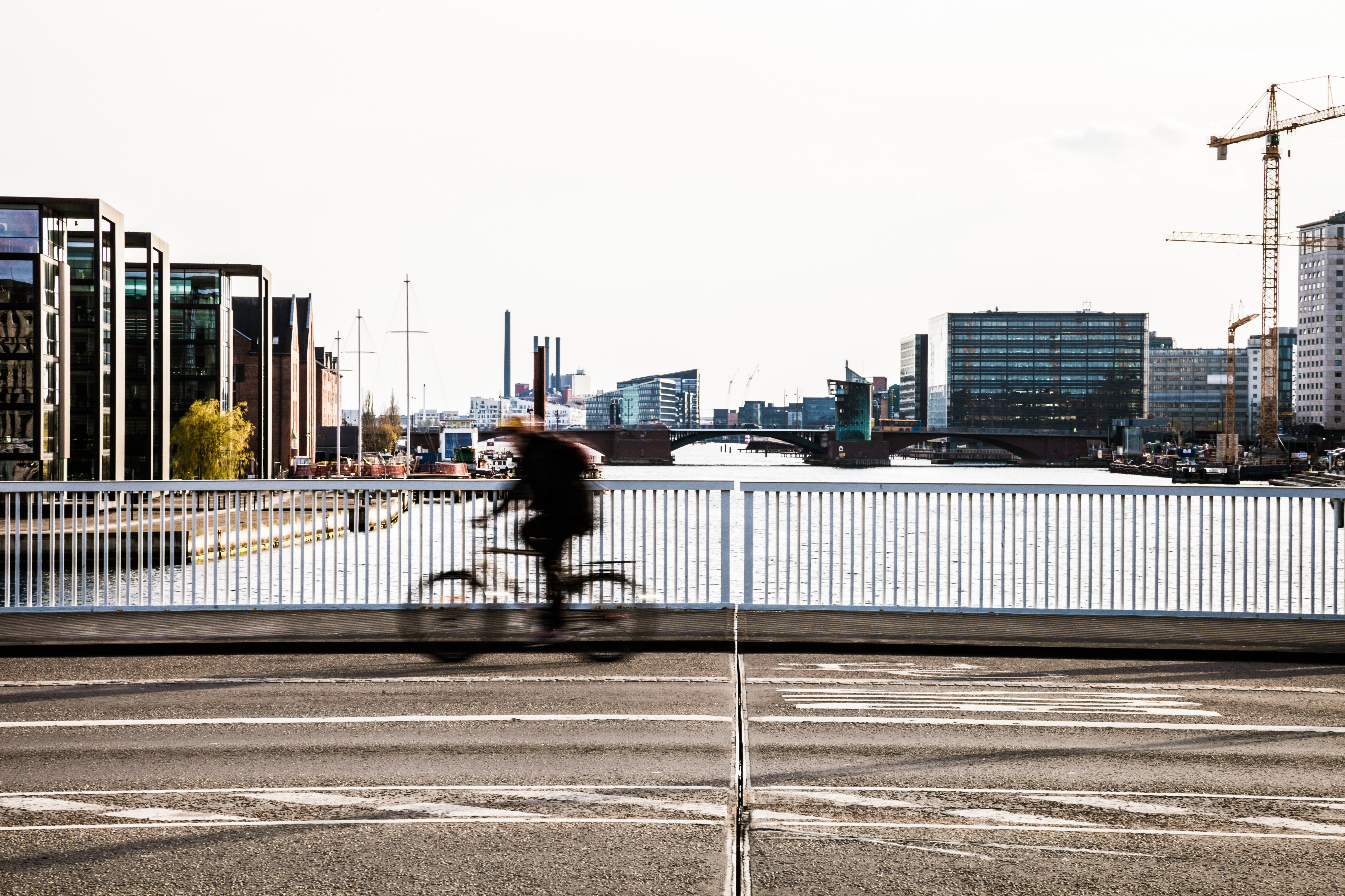 People cycling over a bridge in Copenhagen