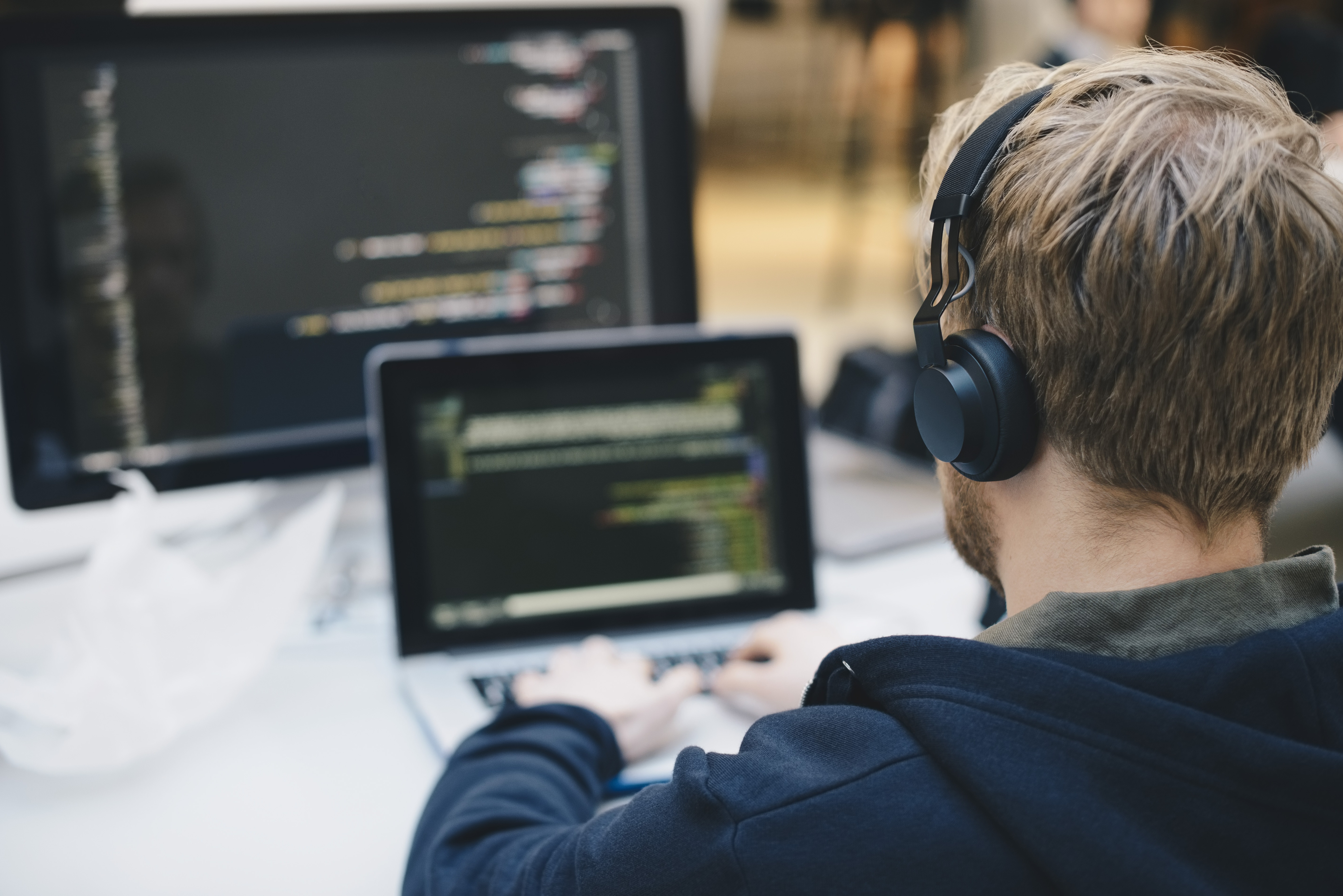 Businessman programming on laptop at creative office