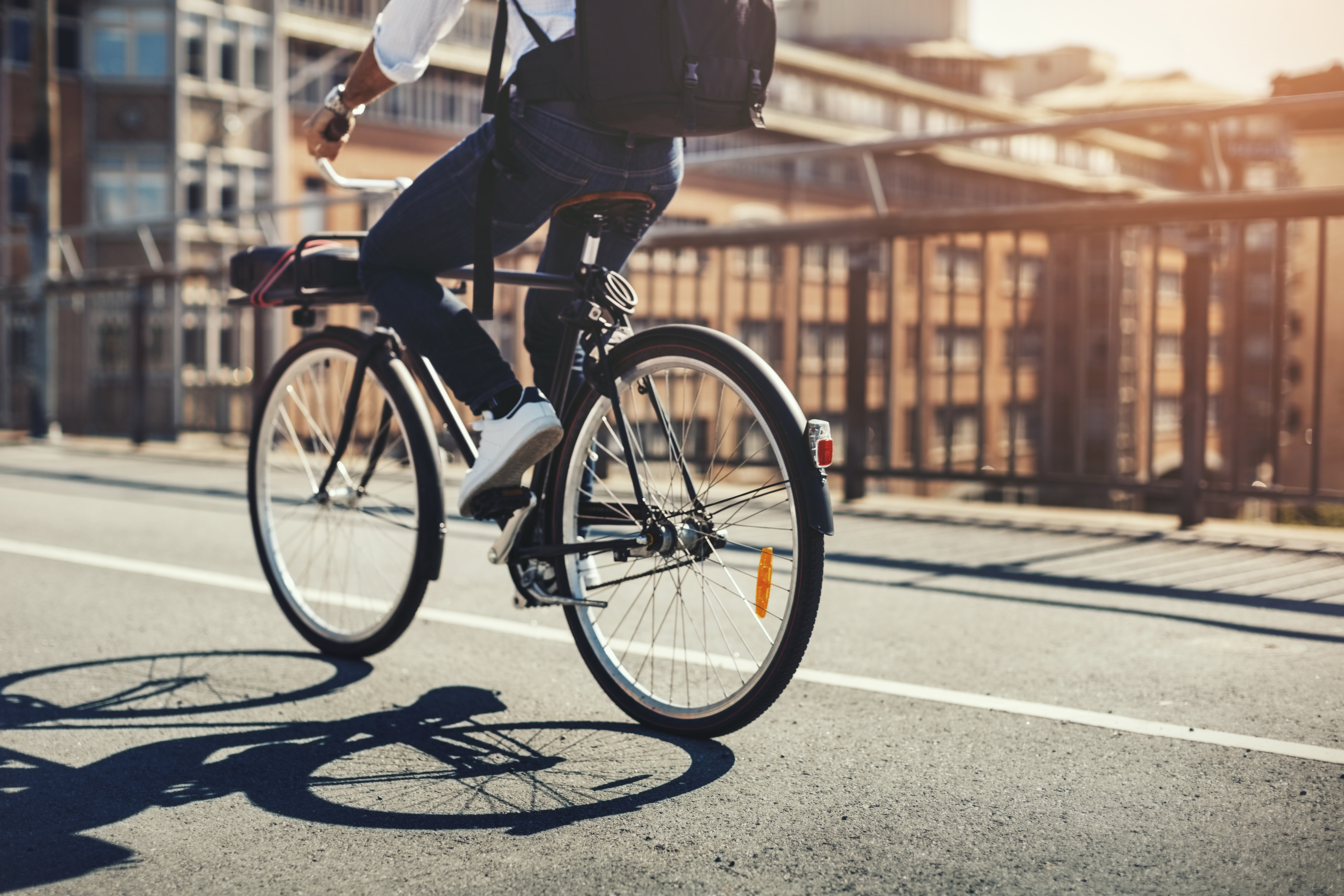 Businessman riding a bike on a bridge