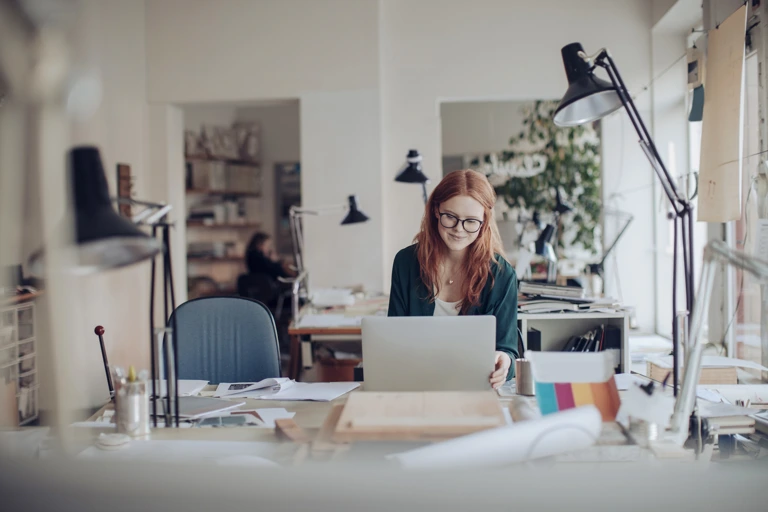 Young woman working on a project with a smile
