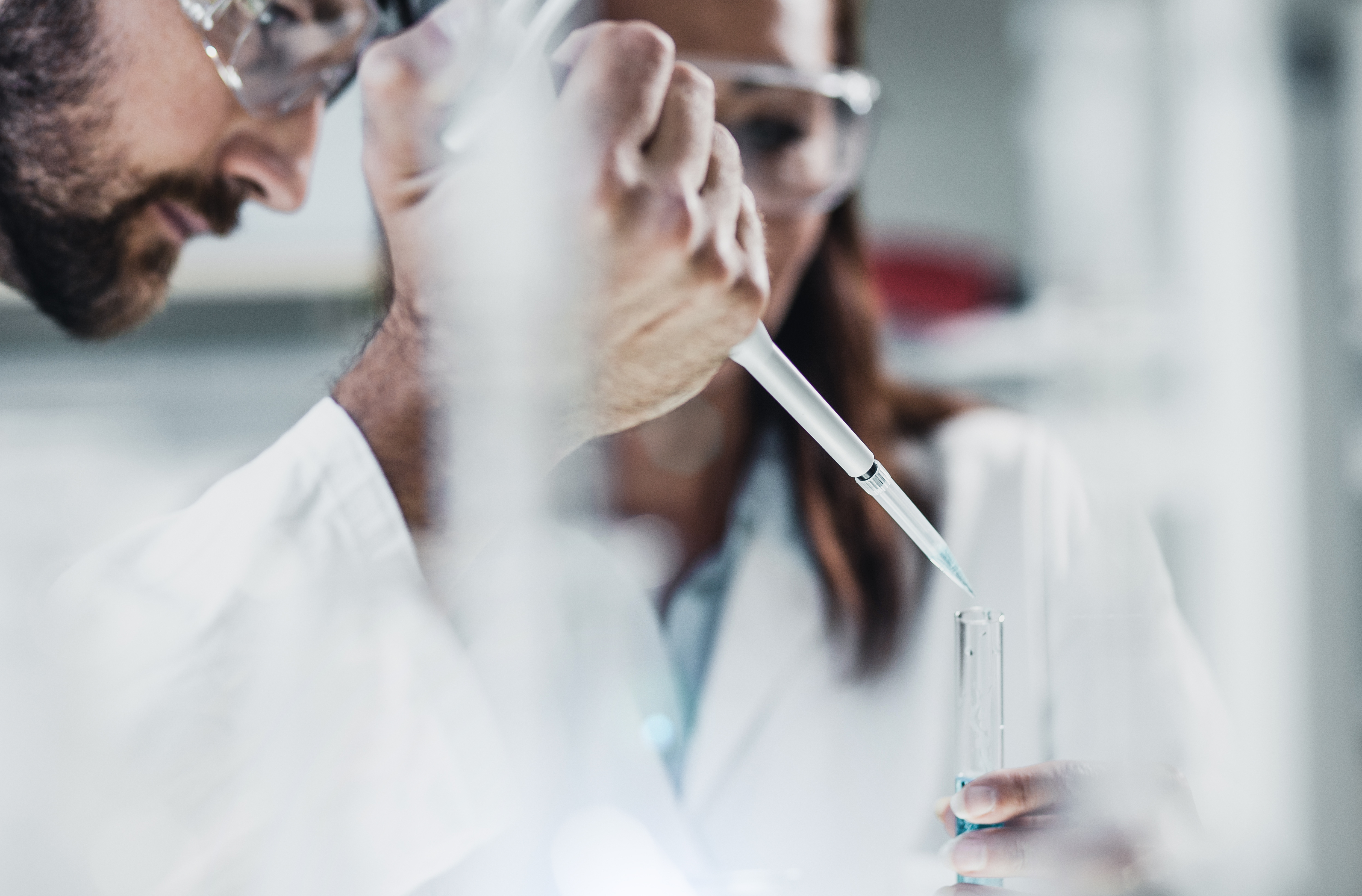 Close-up of a scientist and a pipette