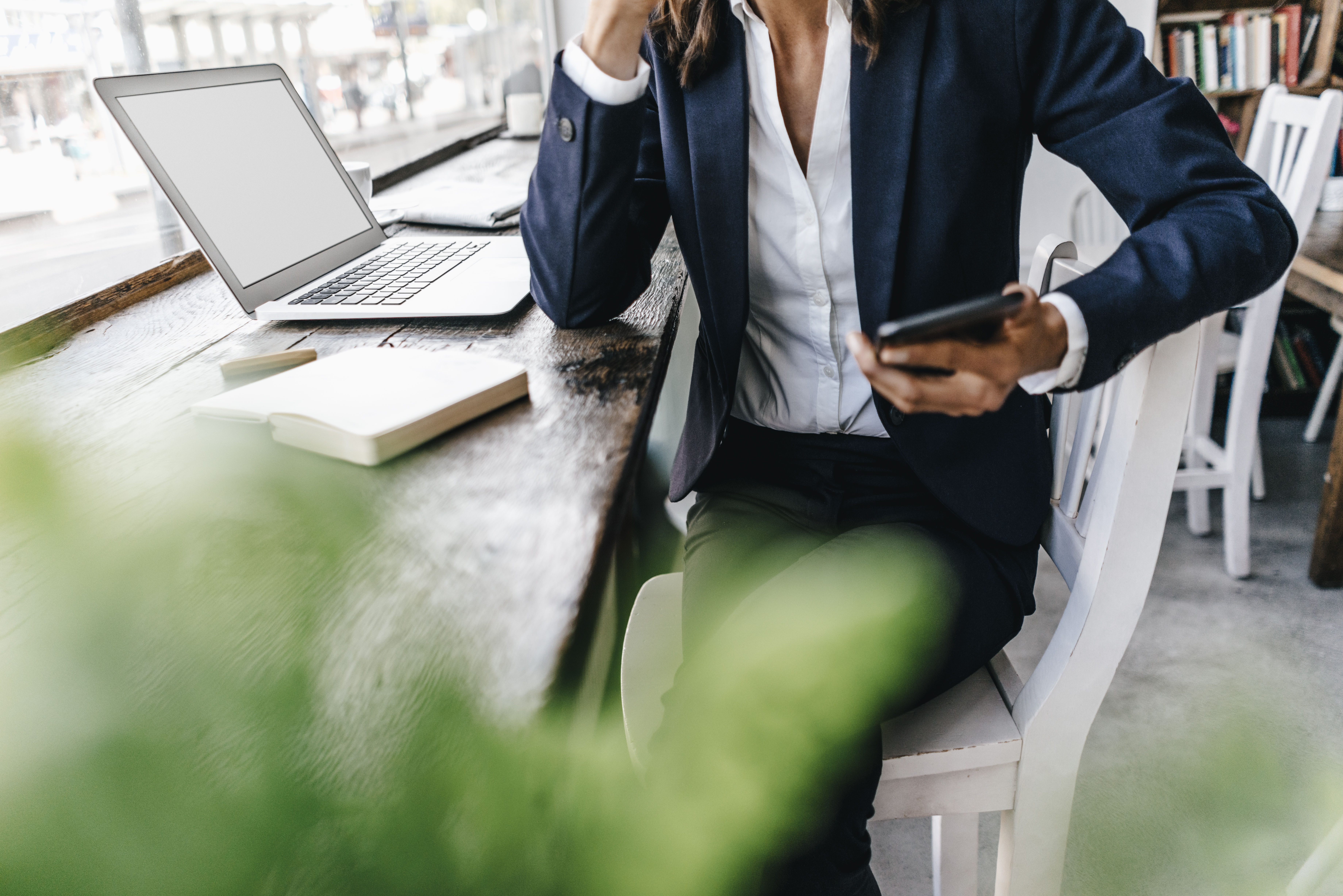 Businesswoman at a cafe using digital tools