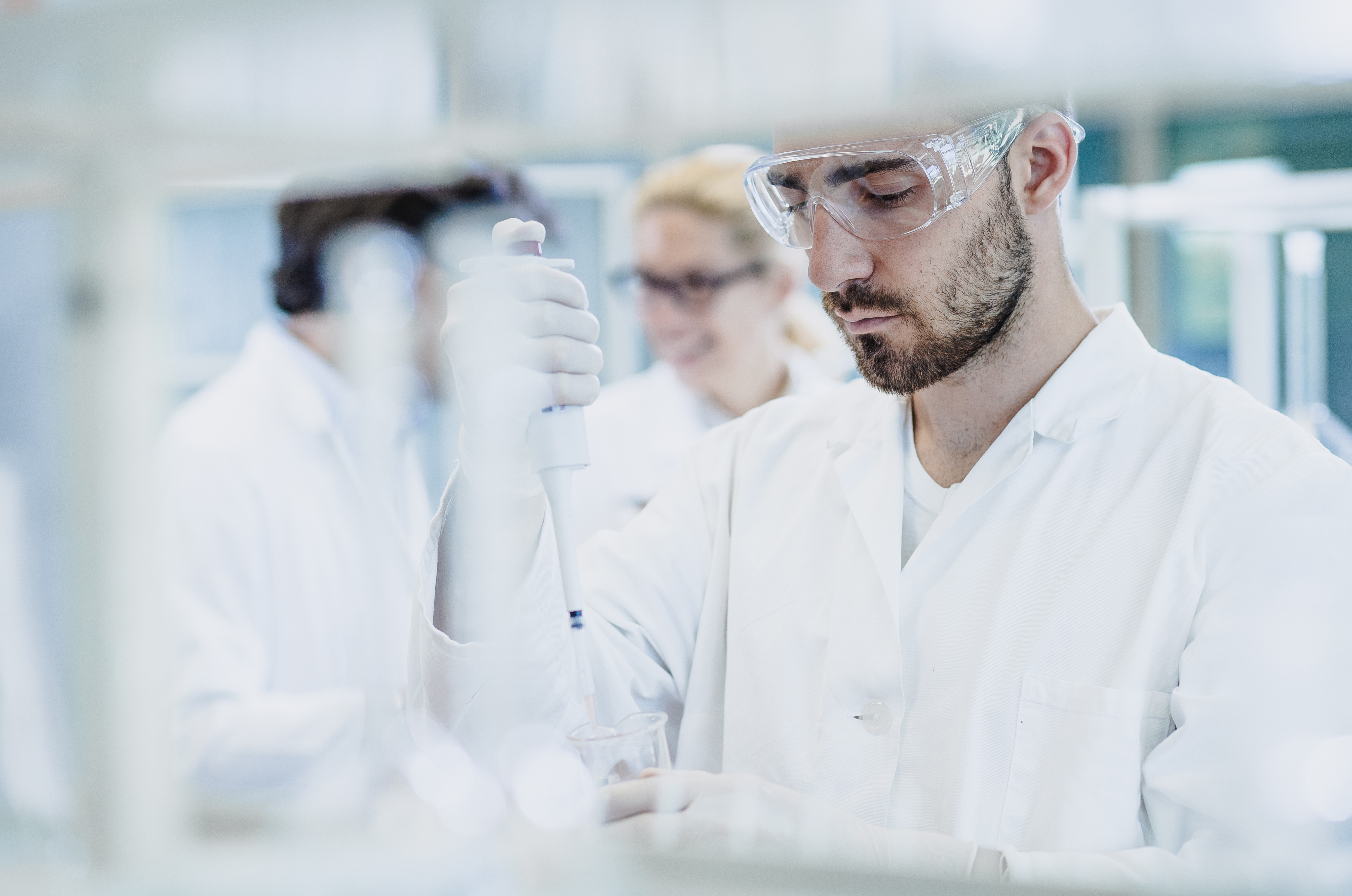 Scientist pipetting into test tube