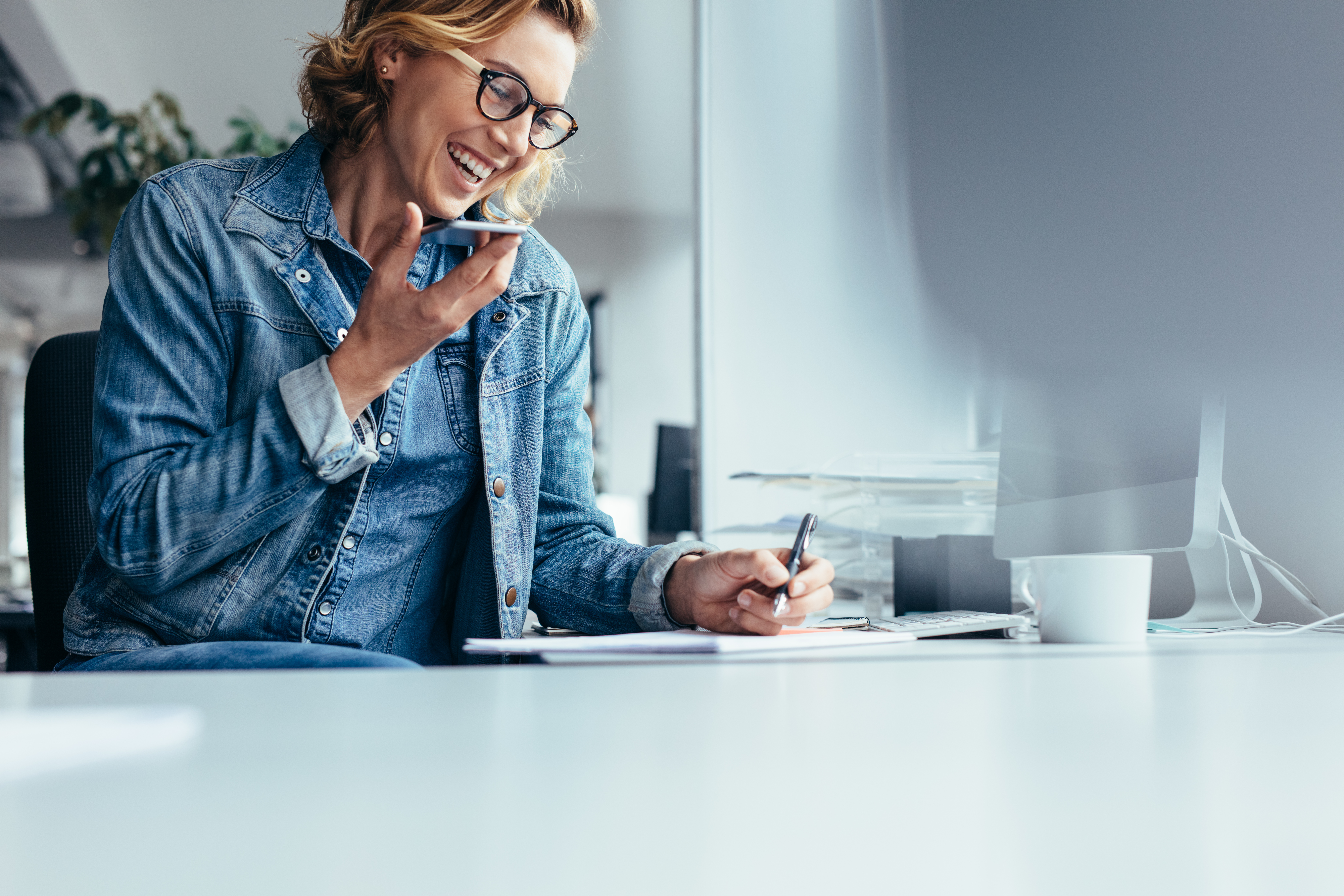 Smiling young businesswoman working at desk